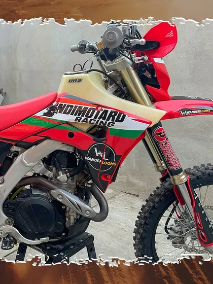 A close-up of our Honda CRF450X, fully built and ready for the Baja 1000. Every component, from the oversized fuel tank to the custom decals, is chosen for performance and durability.