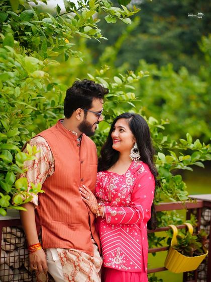 A sweet, romantic portrait of the couple at their Haldi. Their loving gaze and the lush green background create a serene and beautiful image.