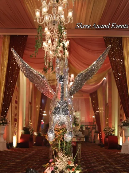 A front-facing view of the majestic mirrored winged horse, positioned as a grand statement piece along the entrance walkway.
