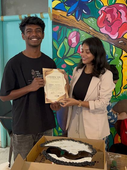 A smiling participant receives his certificate after creating a stunning black and white resin clock during our hands-on workshop.
