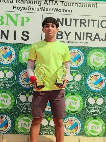 Manan Kumar of NTC with his singles and doubles trophies after winning the CS7 U-18 Boys Singles title and finishing as doubles runner-up.