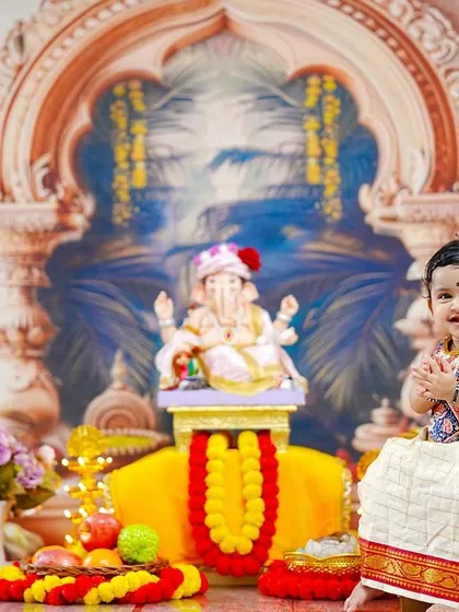 A sweet baby girl in a traditional parkar polka joins her hands in prayer, creating a heartwarming image of youthful devotion.