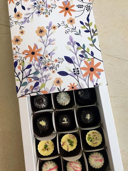 A beautifully designed floral gift box filled with my assorted homemade exotic chocolates. Gifting made elegant and delicious.