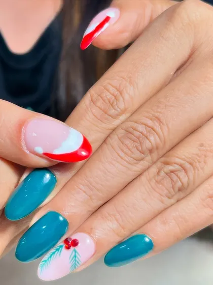 A close-up of the Santa hat and holly nail art. The fine details show the precision and creativity I put into every custom design.