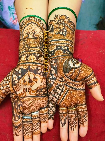 A heavy bridal design featuring peacocks, scales, and other traditional Indian motifs. The work is very dense and detailed.