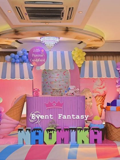 A full stage setup for Naomika's Candyland party. This sweet dream is filled with giant donuts, lollipops, ice cream cones, and a candy shop backdrop, all in a delightful pastel color scheme.