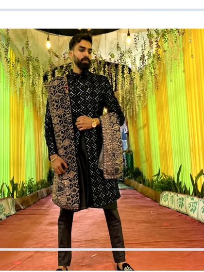 Our client looking confident and stylish in this black embroidered sherwani. The intricate pattern and the matching dupatta make it a standout piece.
