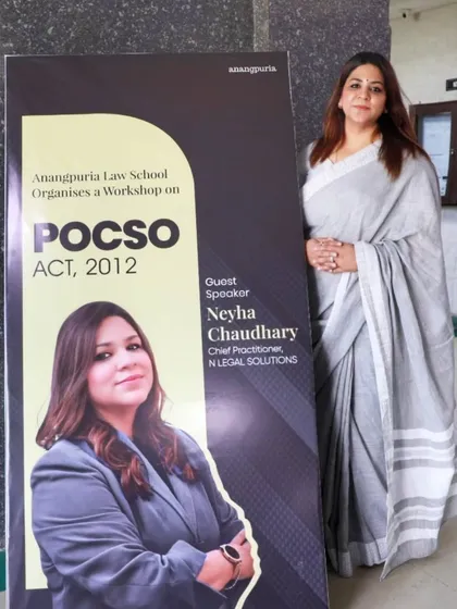 Standing beside a poster for my workshop on the POCSO Act, 2012. I am committed to educating students on the vital role this act plays in protecting children from sexual offenses.