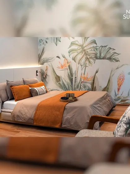 This eco-chic master bedroom brings the tranquility of nature indoors with a stunning botanical feature wall. The design balances minimalist pearl white and oak tones with warm, layered textiles, creating a modern and serene oasis that appeals to contemporary tastes.