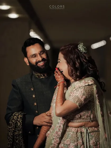 A candid moment of pure joy and laughter between the couple during their reception.