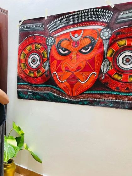 Admiring the unframed Theyyam canvas temporarily hung on my wall. This gives an idea of how the art looks before framing.