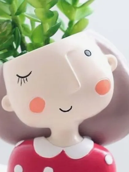 Another one of my adorable character planters, this one with a winking expression and a polka-dot dress. These small pots are perfect for bringing a little bit of joy and green to a small space like a windowsill or work desk.