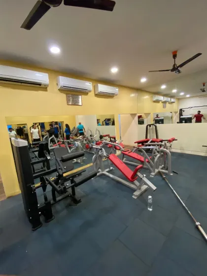 Here is a look at our indoor strength training zone. The space is clean, air-conditioned, and equipped with a variety of machines for a full-body workout, including bench presses and weight stations, all reflected in the full-wall mirrors that help you check your form.