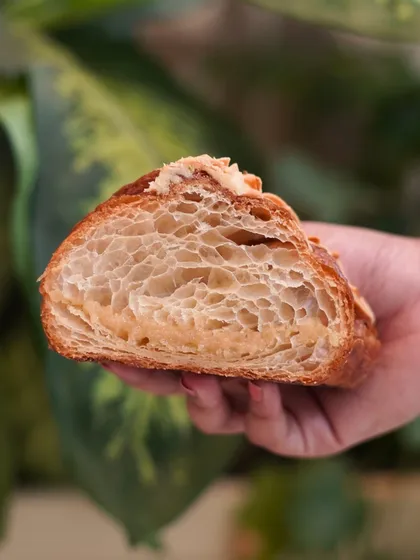 This is what our Almond Croissant looks like on the inside. You can see the honeycomb structure of the pastry, which means it's flaky, buttery, and filled with rich almond cream. We bake these fresh every morning.