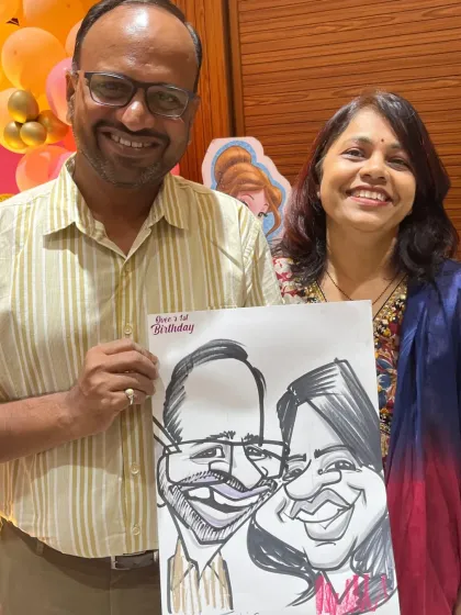 A happy couple with their caricature at Ovee's birthday party. It's great when guests of all ages enjoy the live art.