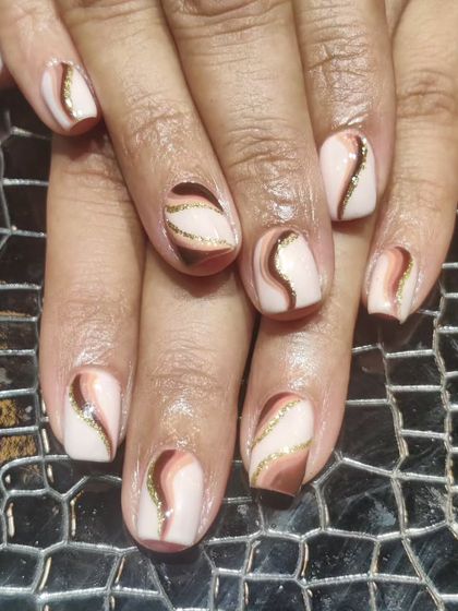 Swirls of chocolate and caramel tones. This abstract design uses different shades of brown with a hint of gold glitter for a chic and trendy look.