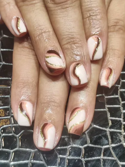 Swirls of chocolate and caramel tones. This abstract design uses different shades of brown with a hint of gold glitter for a chic and trendy look.