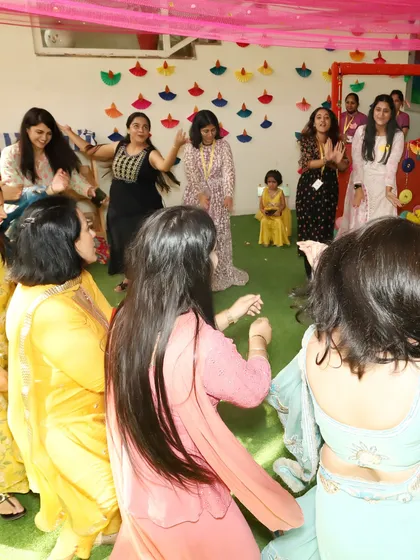 The mothers joining in for a circle dance at our family-friendly Dandiya night. We create an inclusive atmosphere where everyone feels comfortable hitting the dance floor.