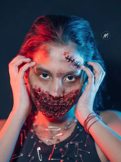 A dramatic shot with coloured lighting to enhance the horror effect of the SFX makeup.