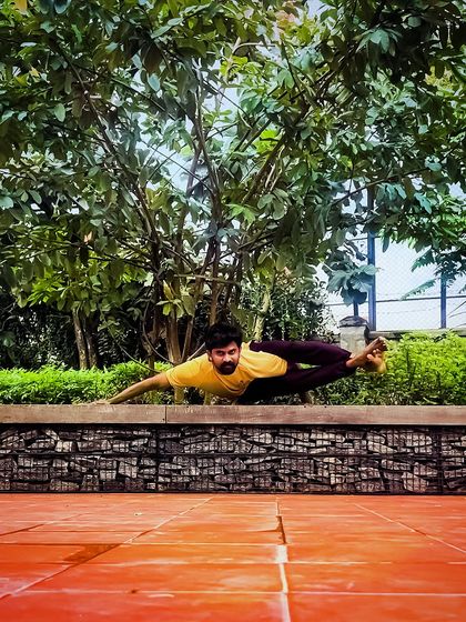 Taking my practice outdoors with an arm balance that mimics the form of a grasshopper. This pose, Parsva Bhuja Dandasana, requires twisting, core strength, and balance, connecting me with the nature around me.