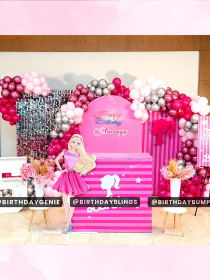 This complete Barbie party setup features a stunning photo booth with a life-sized Barbie, a shimmer wall, and a custom-branded cake table. The vibrant pink balloon arch and themed welcome sign create an immersive and glamorous experience from the moment guests arrive.