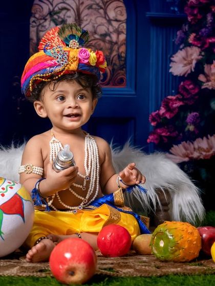Our little Krishna wishes you a very Happy Krishna Janmashtami, surrounded by fruits and his pot of butter.