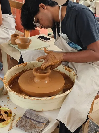 A student in a one-day workshop trying his hand at the potter's wheel. It's a great activity for anyone looking to explore their creative side.