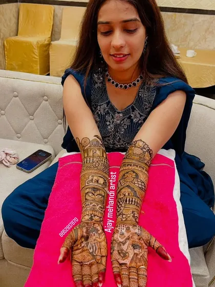 Another shot of the happy bride, proudly displaying her beautiful and detailed bridal mehndi.