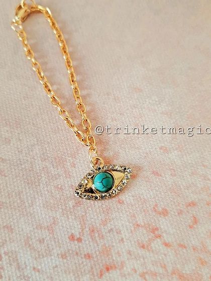 A hot-selling product, this turquoise evil eye watch charm is perfect for adding a pop of color and protection to your wrist.