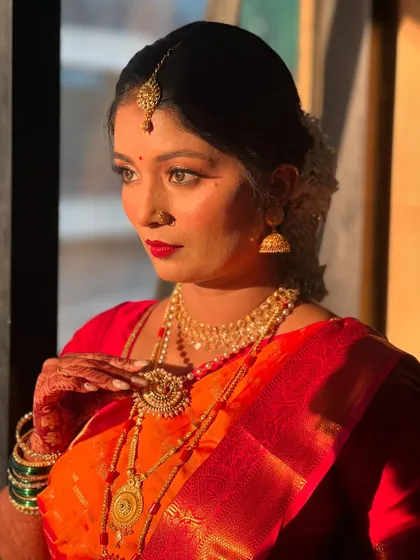 A classic, thoughtful pose that highlights the intricate details of her makeup and jewellery.