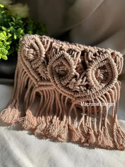 A close-up of the detailed knot work on our owl-themed macramé sling bag. The design features two large "eyes" and a fringed bottom, giving it a whimsical, bohemian feel.