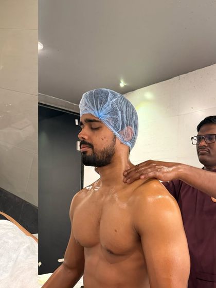 A therapist works on an athlete's shoulder, a common area of strain. This targeted Abhyangam helps release knots and improve mobility, preventing injury and enhancing performance.