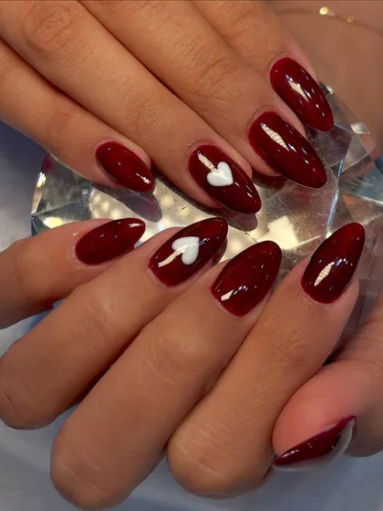 A perfect set for Valentine's Day or any time you want to show some love. This design features a deep, glossy burgundy polish with a crisp, white 3D heart accent nail.