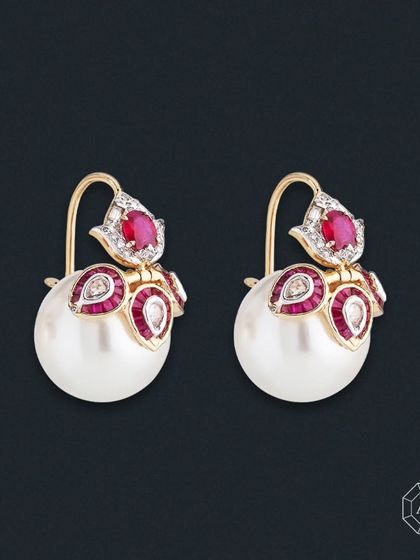 Bring a bit of sparkle to your day with our gorgeous pearl earrings. Featuring lustrous Taiwanese pearls, vibrant African rubies, and dazzling round and baguette diamonds, they offer a sophisticated yet bold look.