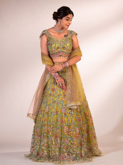 A full-length shot of the green floral lehenga, showing how beautifully it drapes. The perfect outfit for a mehndi or haldi ceremony.