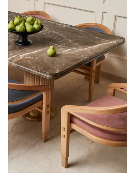 The dining space is subtle yet impactful, with a bespoke marble-topped table and custom chairs upholstered in contrasting colors. The design is clean, elegant, and functional.