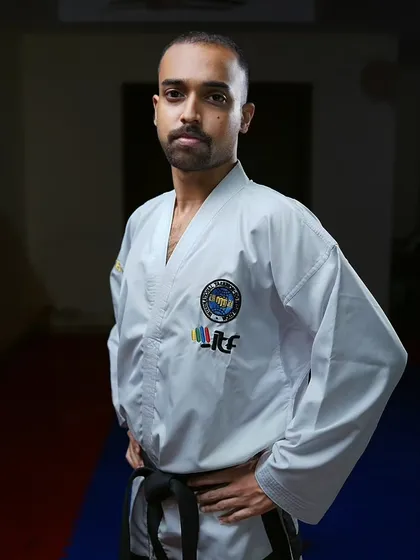 A portrait in my dobok. The uniform represents a commitment to continuous learning and upholding the tenets of Taekwon-Do: courtesy, integrity, perseverance, self-control, and indomitable spirit.