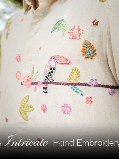 A close-up of the intricate hand-embroidery on our Toucan shirt. This piece is perfect for your next tropical getaway, bringing a touch of toucan-tastic adventure to your wardrobe.