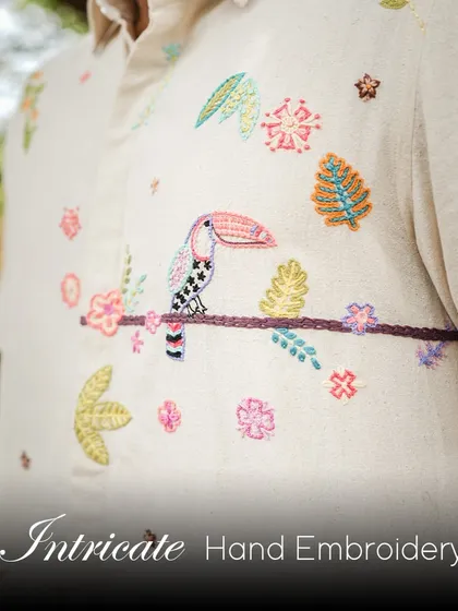 A close-up of the intricate hand-embroidery on our Toucan shirt. This piece is perfect for your next tropical getaway, bringing a touch of toucan-tastic adventure to your wardrobe.