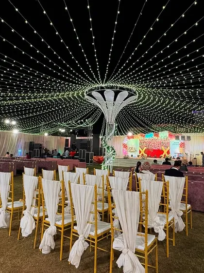Lighting can completely transform a space. For this outdoor event, I created a stunning canopy of fairy lights radiating from a central structure, making the entire lawn feel like it's under a sky full of stars.