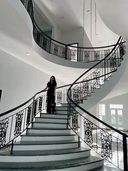 The centerpiece of this Lonavala site is the magnificent curved staircase with custom wrought iron railings. It is a testament to my belief that architectural elements should be both functional and sculptural, adding a sense of drama and movement to the home.