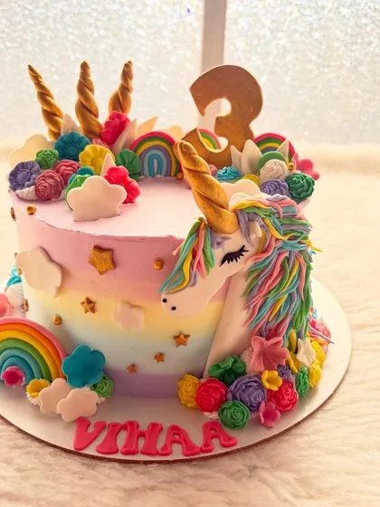 A magical unicorn cake for a third birthday. I handcraft every detail, from the rainbow buttercream and golden horn to the colorful mane, to create a truly enchanting centerpiece for a special day.