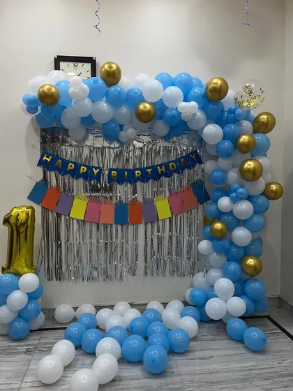 The complete balloon arch with gold chrome accents, perfect for a small celebration.