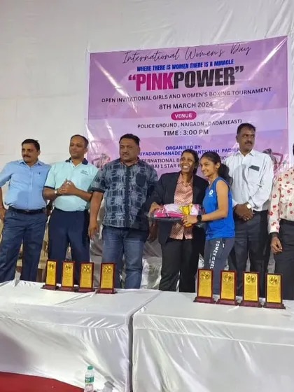 Our female boxer receiving her award at the "Pink Power" tournament. We encourage and celebrate our women fighters.