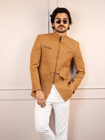 The tan zipper bandhgala, styled for a confident and relaxed pose. The unique cut at the hem adds another layer of modern design to this versatile piece.
