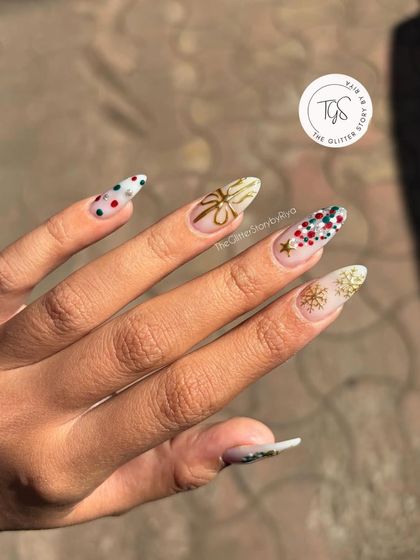 An intricate and festive holiday manicure. Each nail tells a part of the Christmas story with hand-painted gold bows, snowflakes, and colorful polka dots.