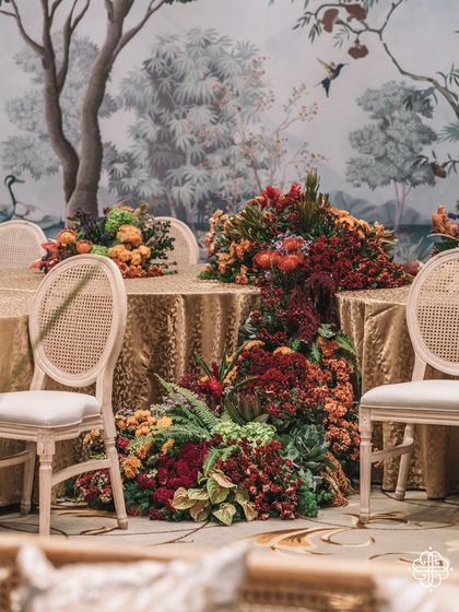 A wide view of the 'Orchard of Life' tables, with cascading floral runners creating a sense of abundance.