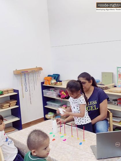 A child and her mother work together on a counting and sequencing activity. I encourage parental involvement as it strengthens the learning experience and makes it a fun, shared activity.