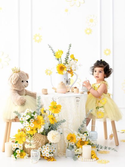 A wider shot of the enchanting tea party setup. This shows how all the elements come together to create a beautiful, immersive scene for a themed toddler photoshoot.