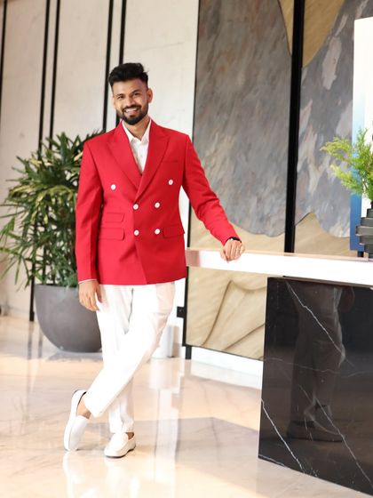 The full ensemble, styled with crisp white trousers and matching shoes. This is a perfect example of a modern ceremonial look that is both bold and elegant.